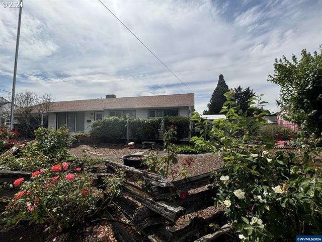 a view of a house with sitting area and garden