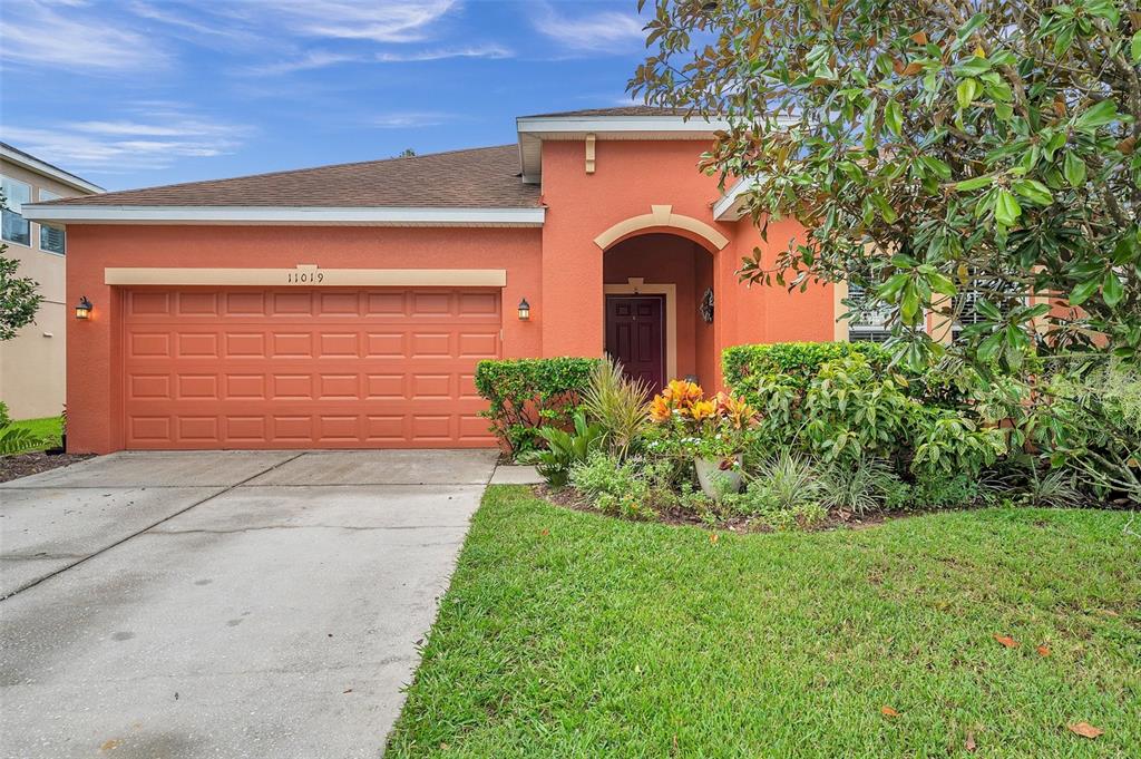 a front view of a house with a yard and garage