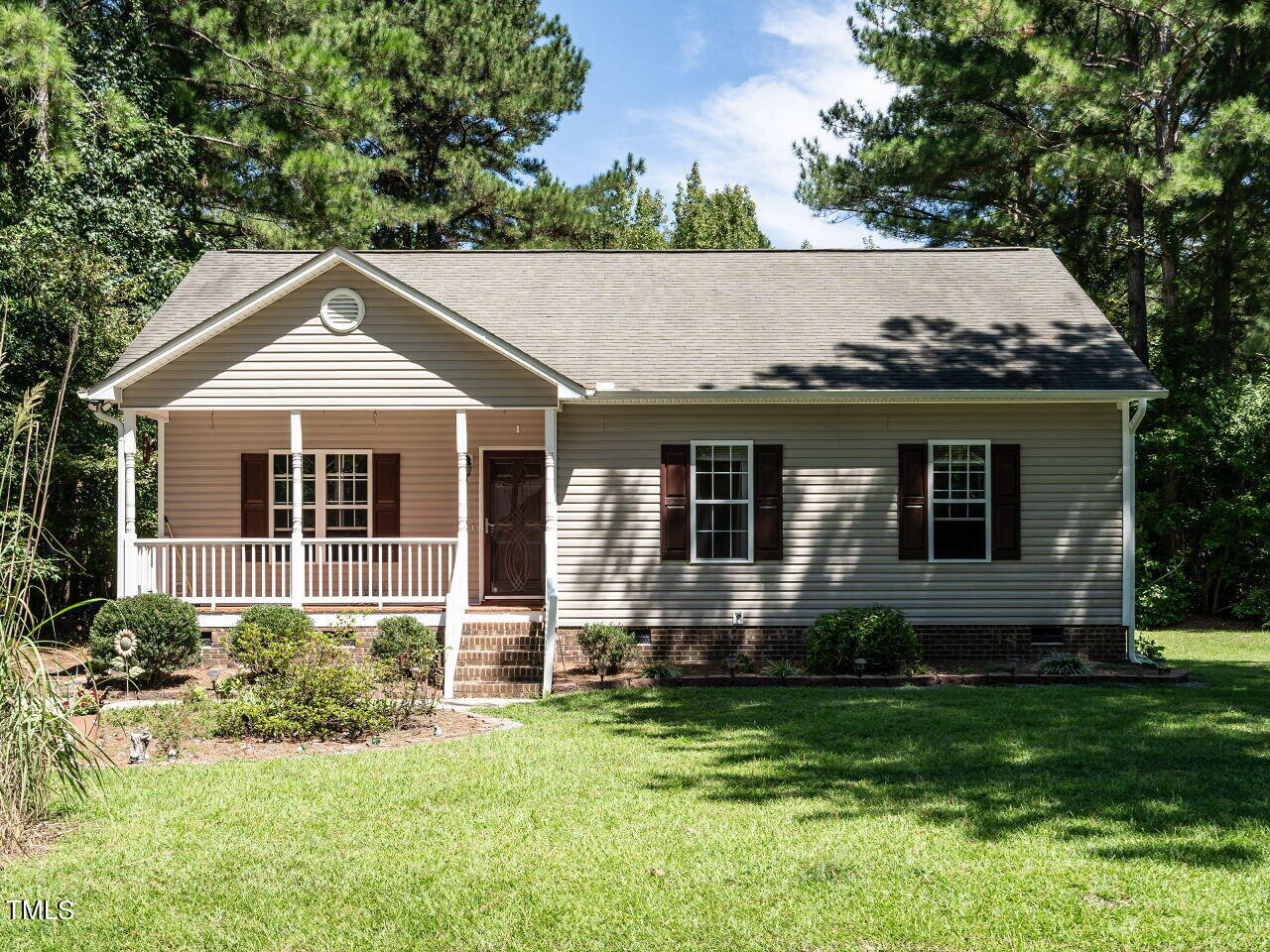 a front view of a house with a yard and porch