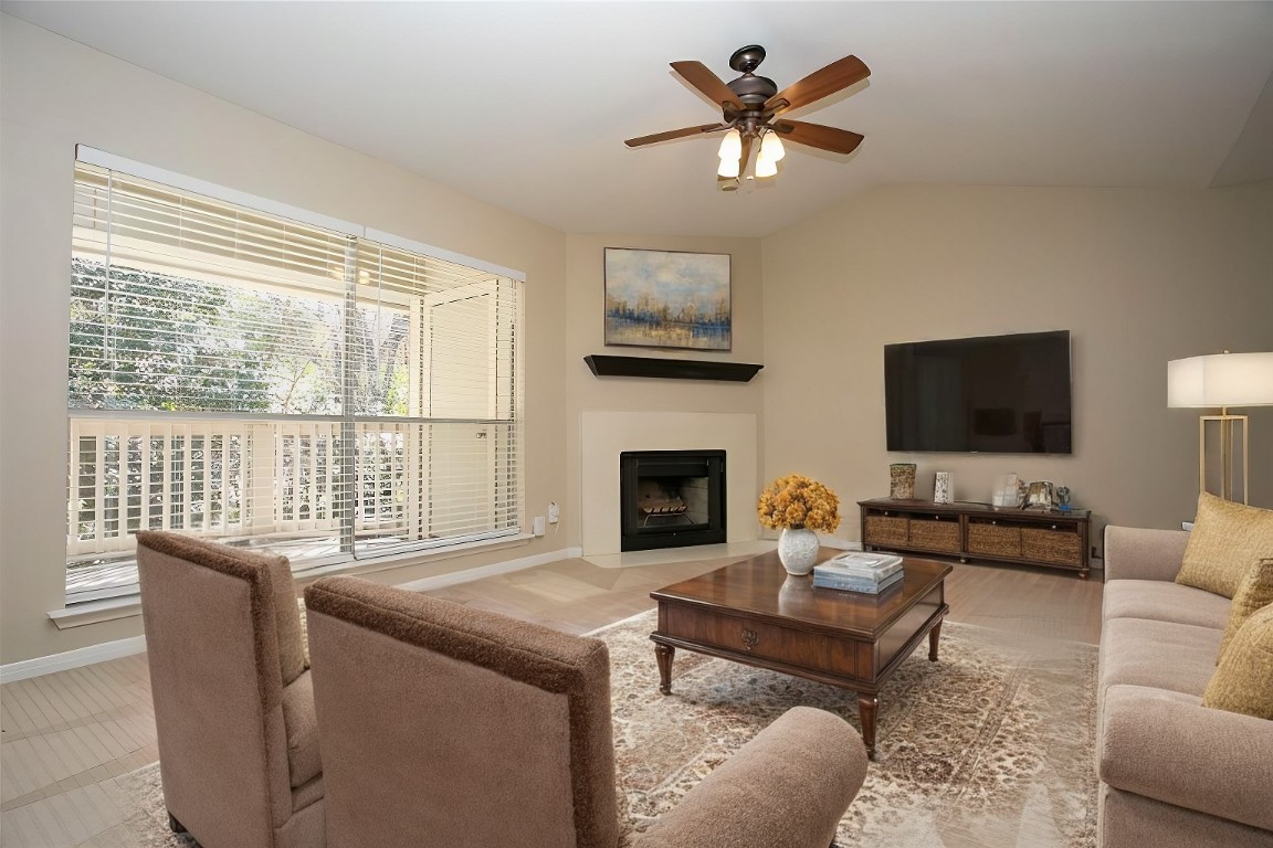 a living room with furniture a fireplace and a flat screen tv