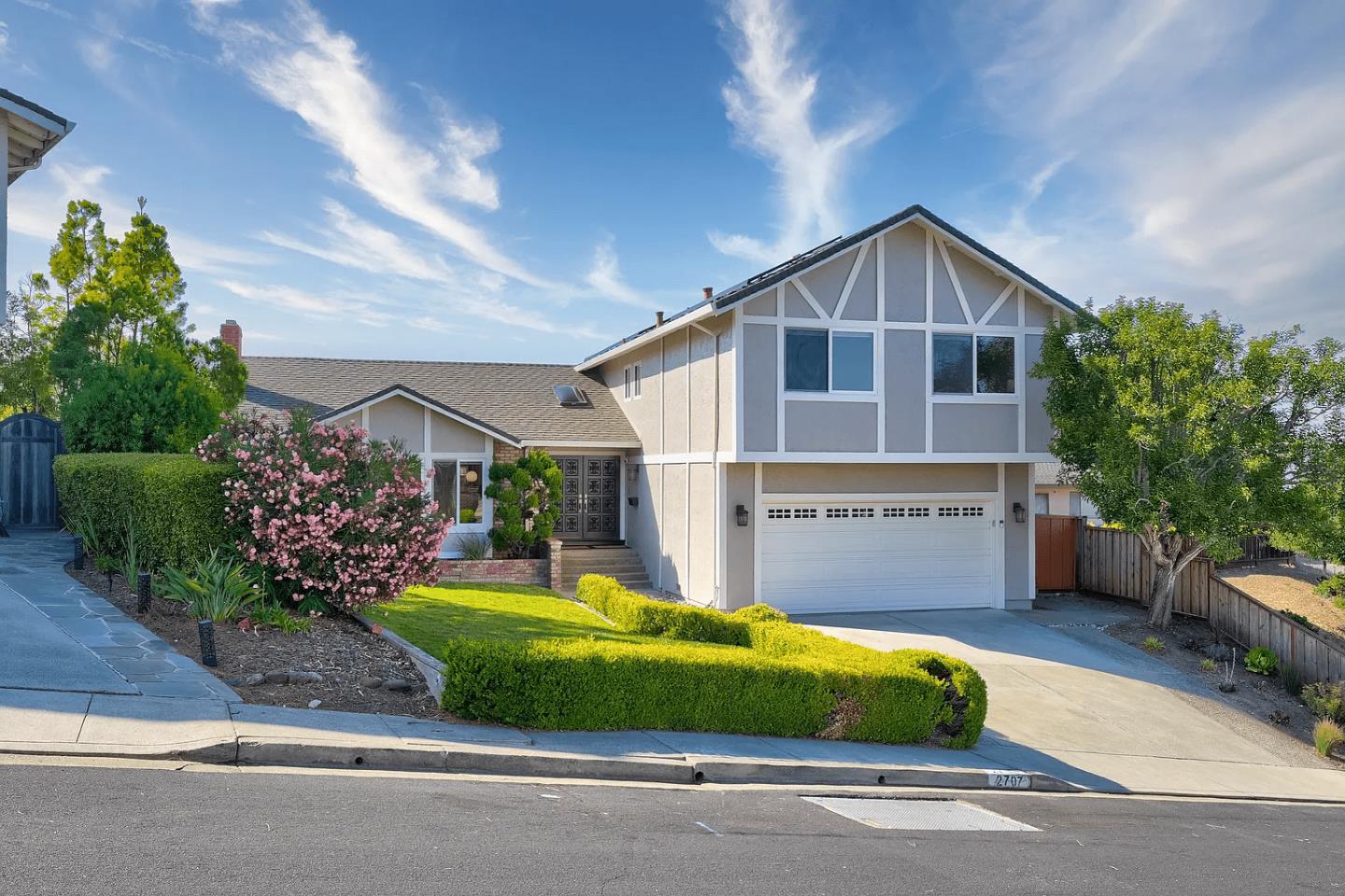 a view of a house with a yard and garage