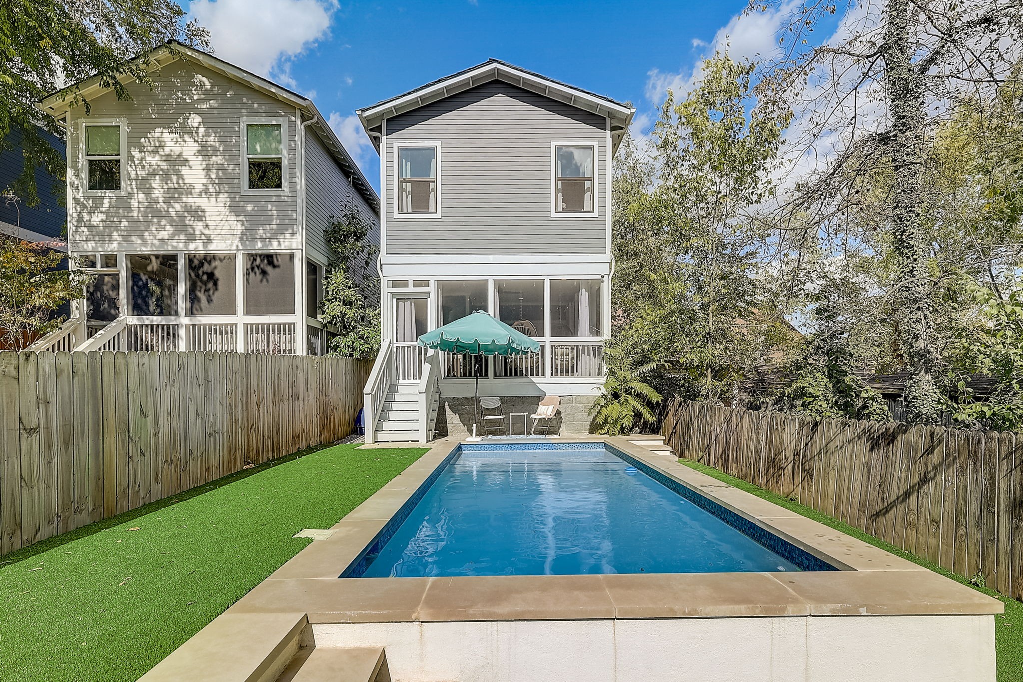 a view of house with backyard and seating space