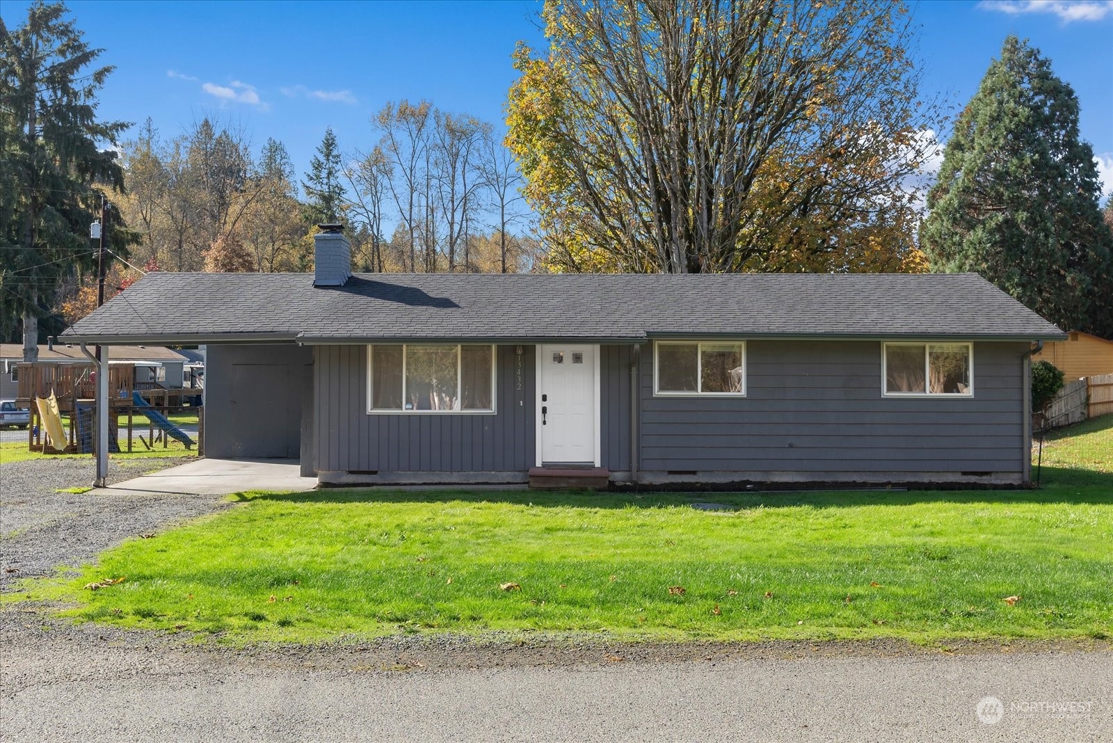 a view of a house with a yard and tree