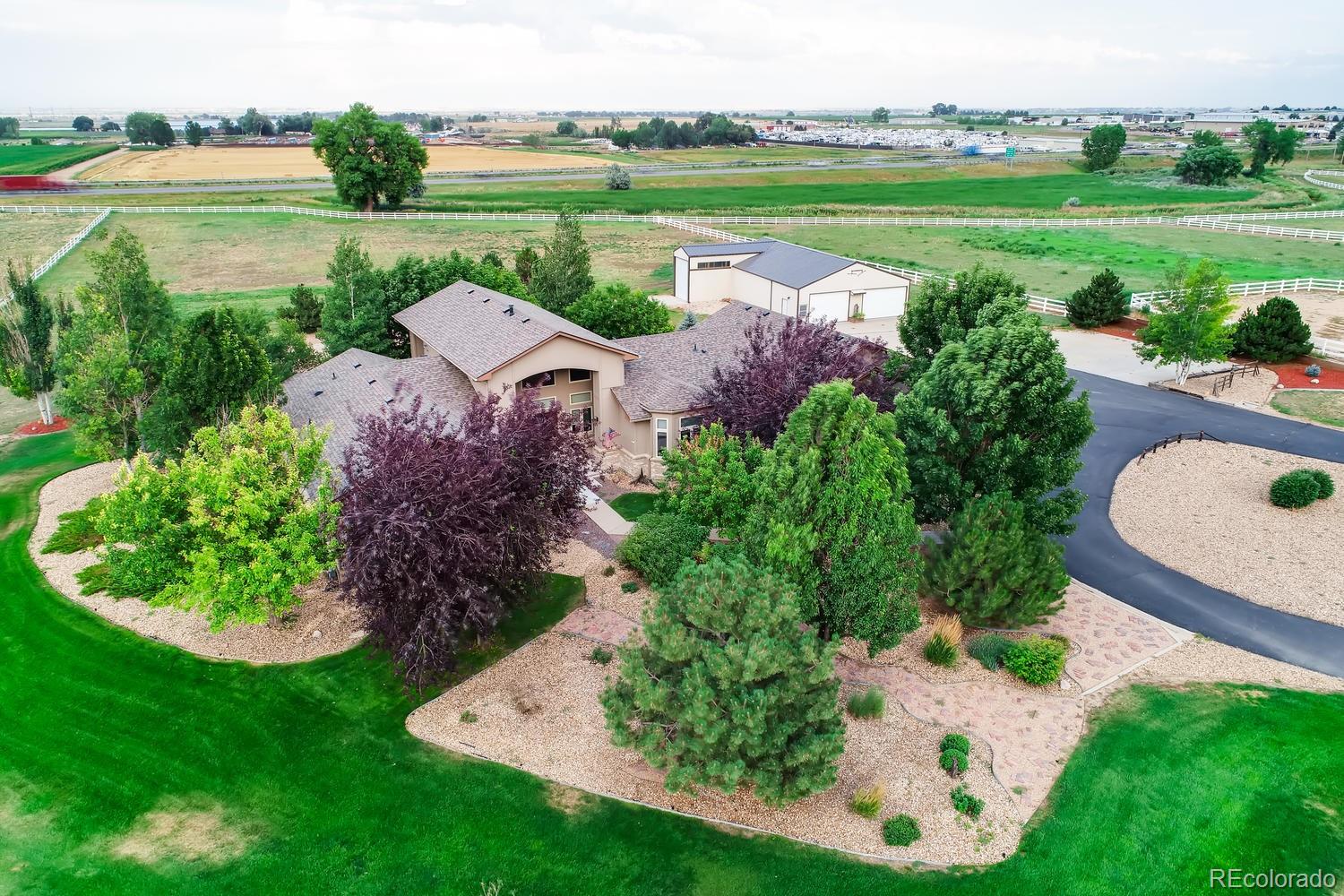 an aerial view of a house with a garden and lake view