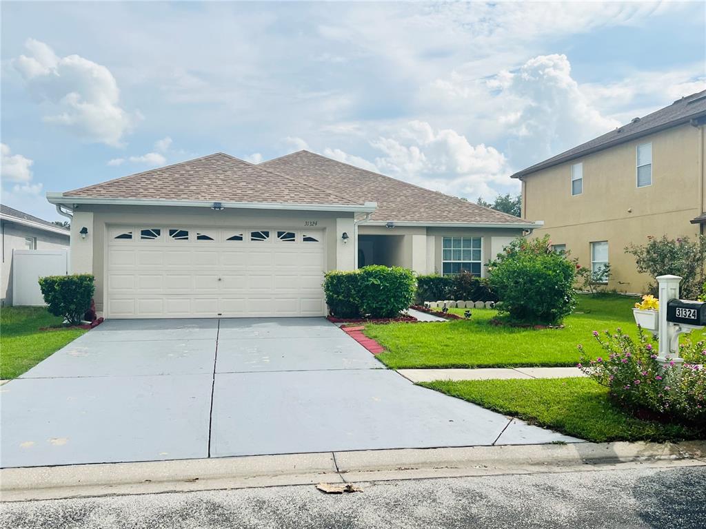 a front view of a house with a yard and garage