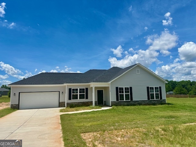 a front view of a house with a garden