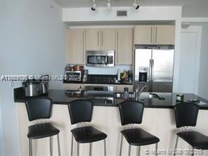 a kitchen with a stove cabinets and dining table