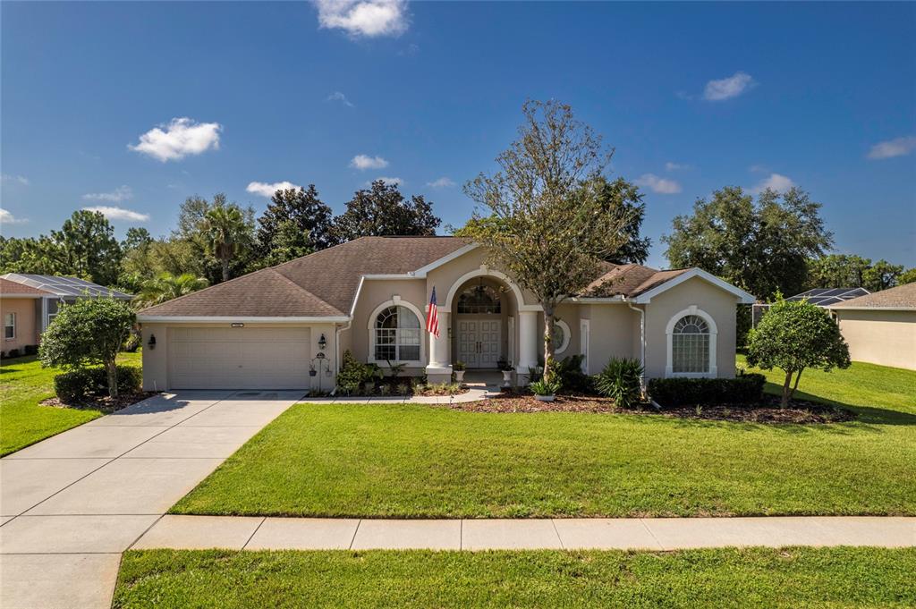 a front view of a house with a yard and garage