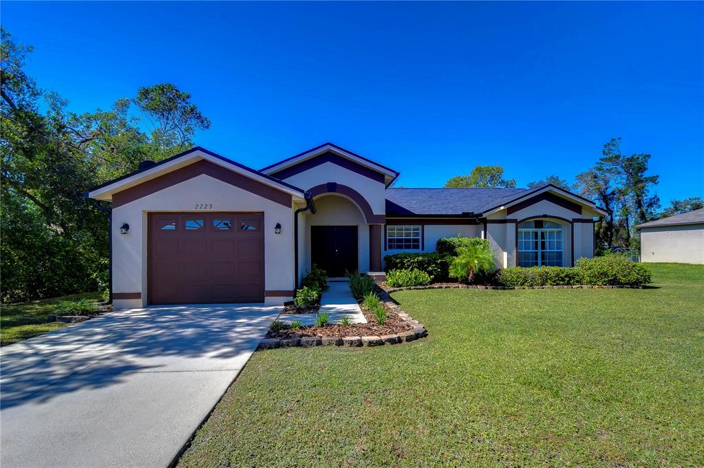 a front view of a house with a yard and garage