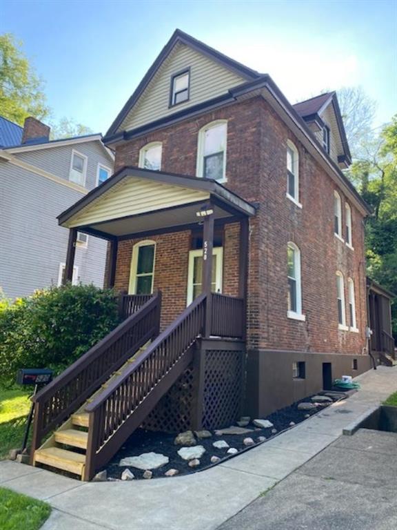 a front view of a house with yard