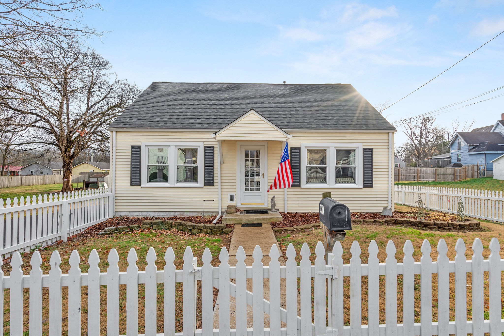 a front view of a house with a garden