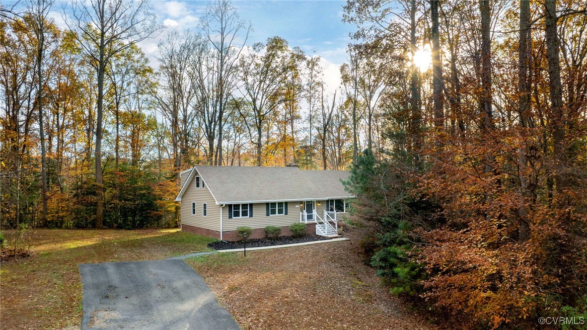 View of front of house with a porch and a front la