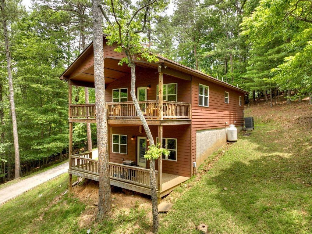 a view of house with backyard outdoor seating and hardwood