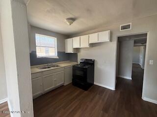 a kitchen with a refrigerator and a stove top oven