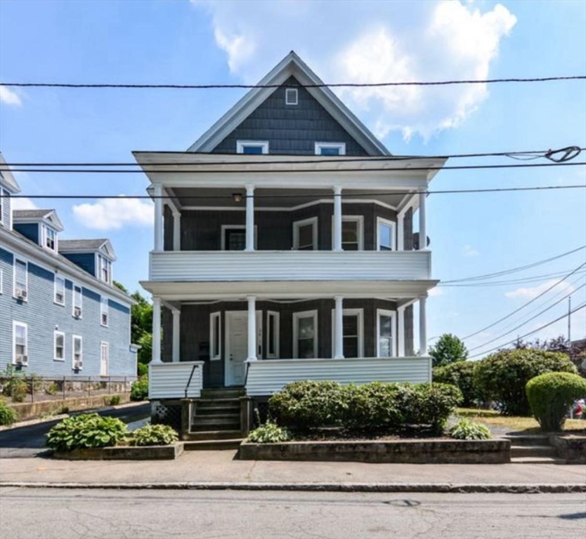 a front view of a house with a garden