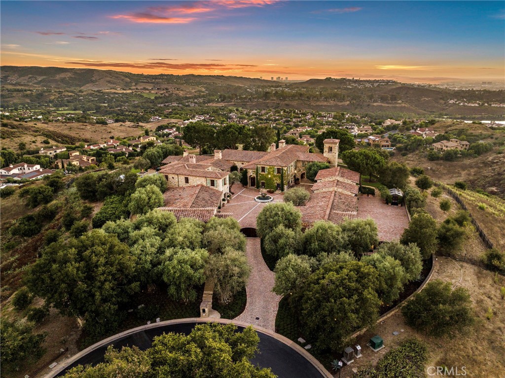 an aerial view of residential houses with city view