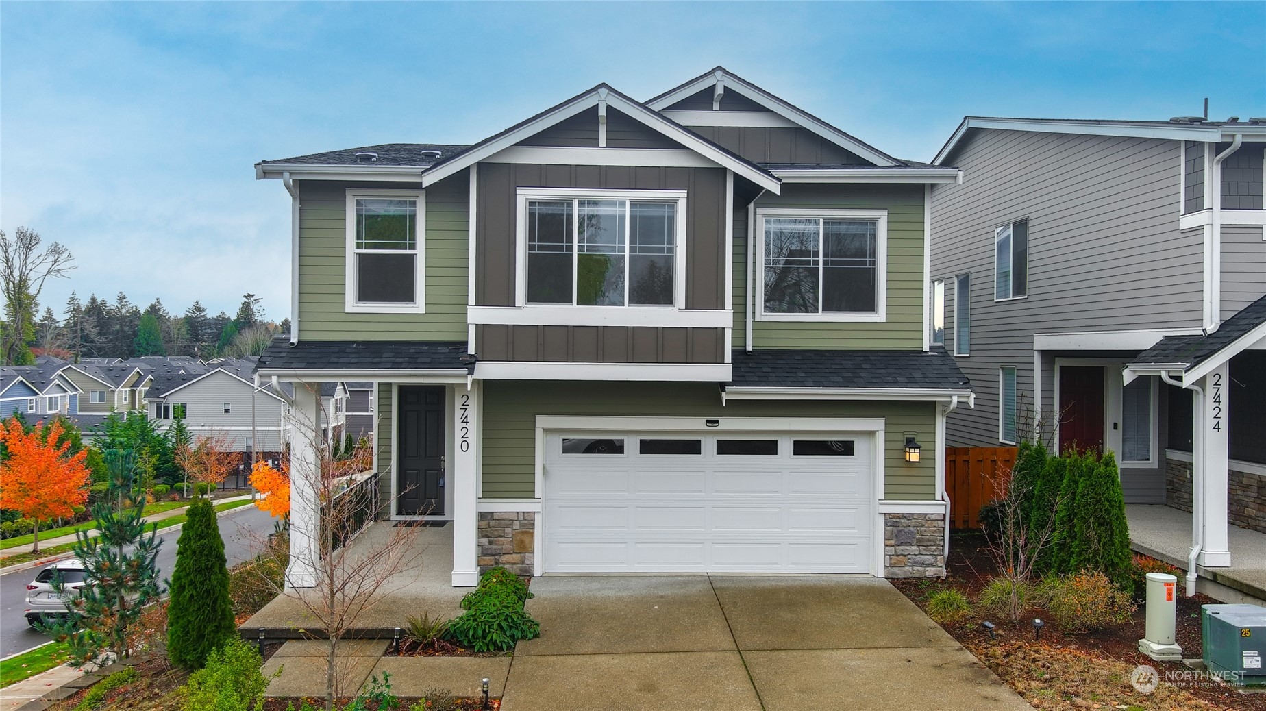 a front view of a house with a yard and garage