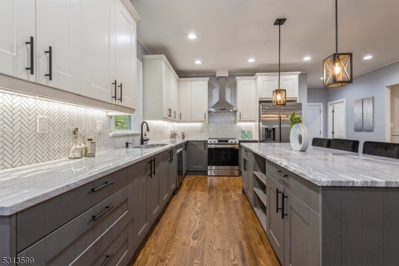 a large kitchen with stainless steel appliances kitchen island a large island in the center