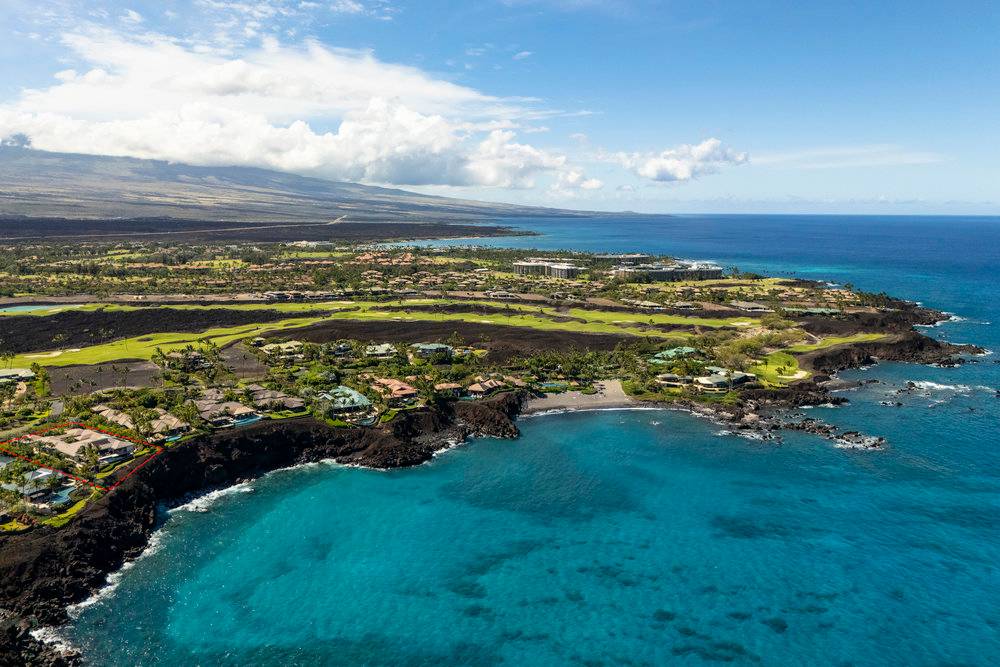 a view of a golf course with an ocean