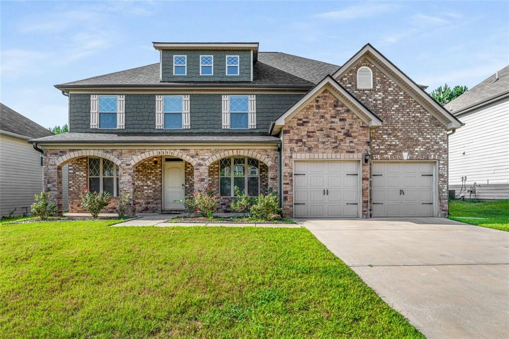 front view of a house with a yard