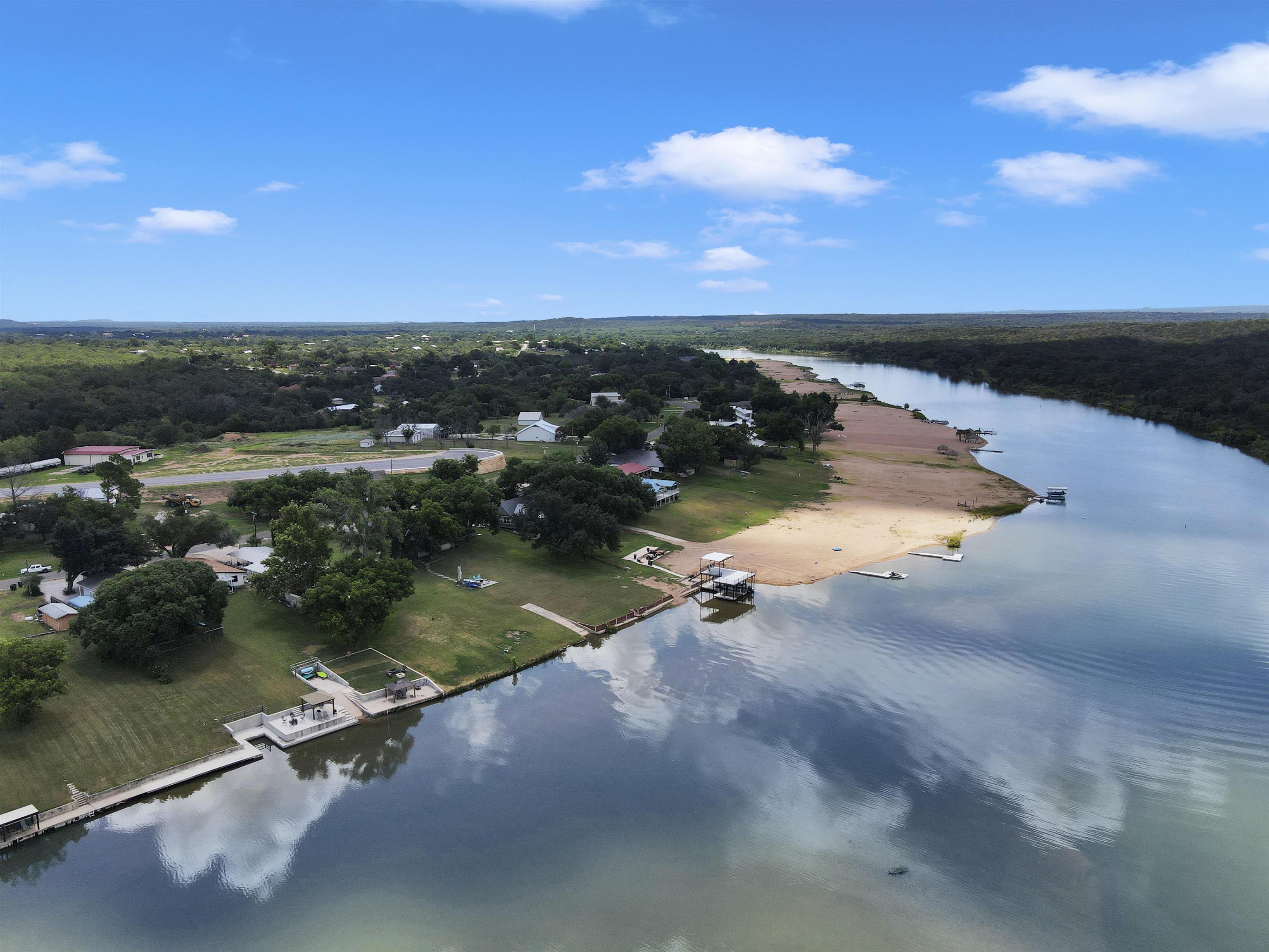 an aerial view of a house with a yard and lake view