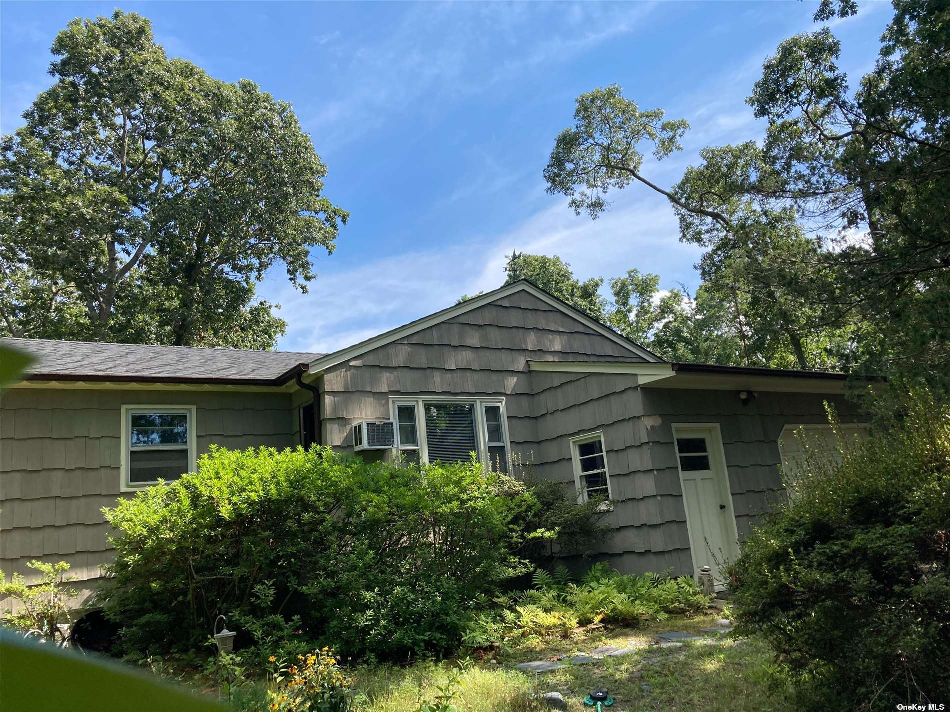 front view of a house with a garden