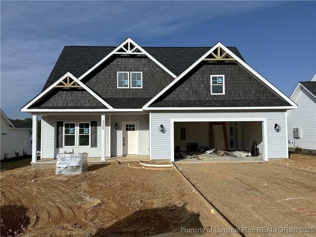 a front view of a house with yard and garage