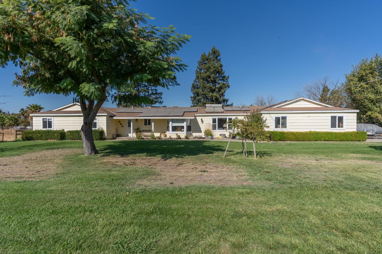 a front view of a house with a garden