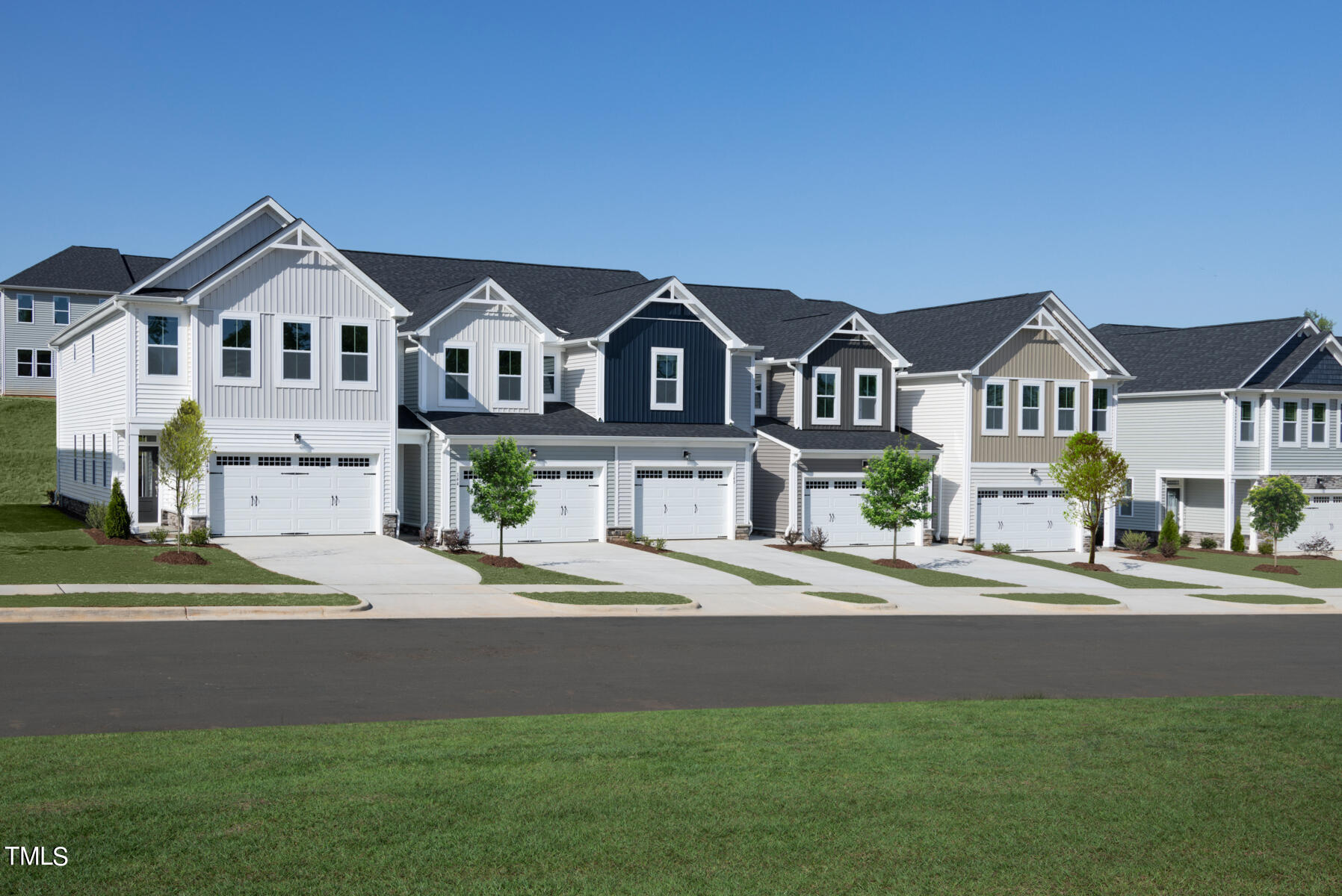 a front view of a house with a garden and yard