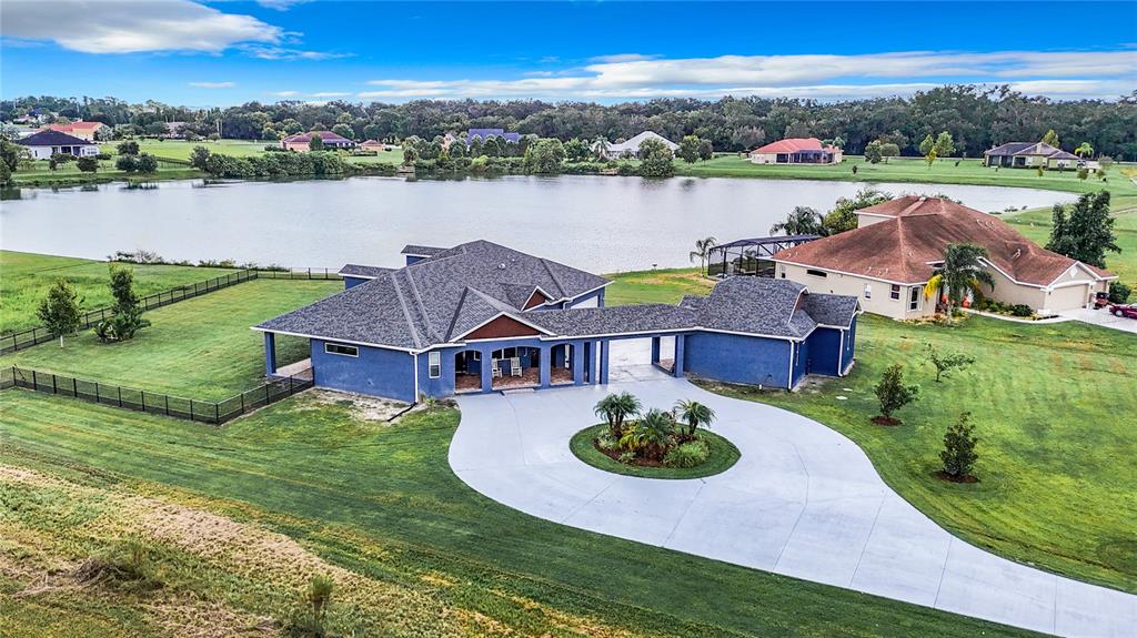 an aerial view of a house with outdoor space swimming pool and lake view