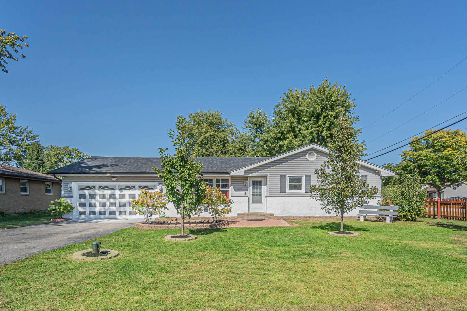 a front view of a house with a garden