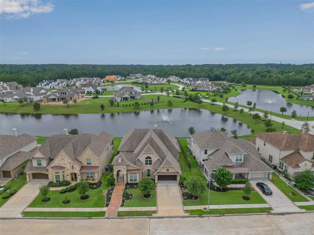 an aerial view of a house with a garden and lake view