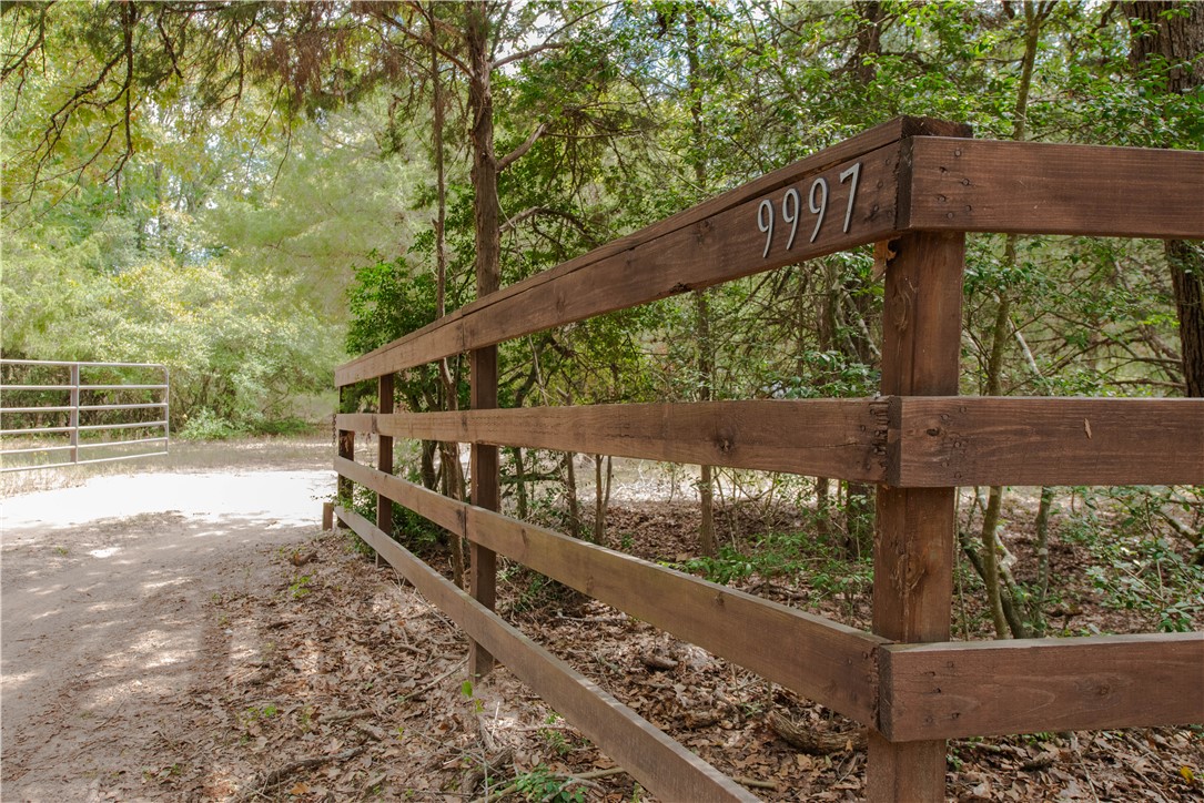 a view of a street with wooden fence