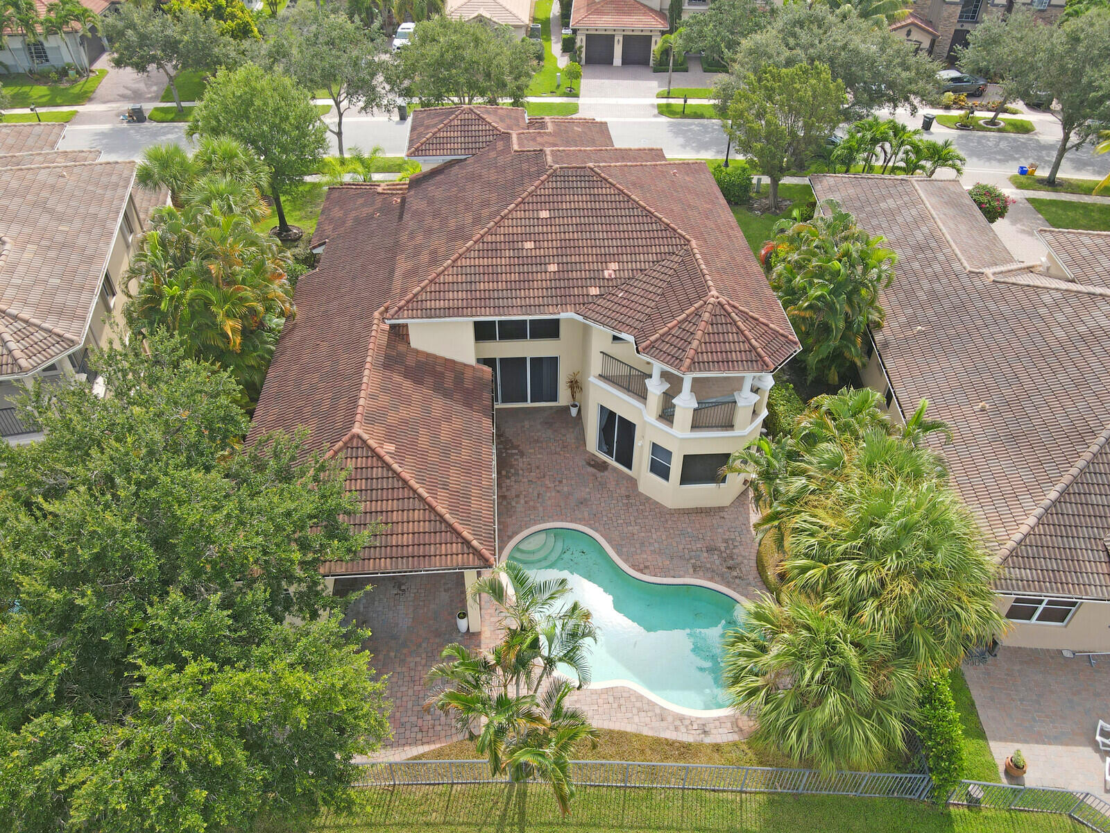 an aerial view of a house with garden space and street view