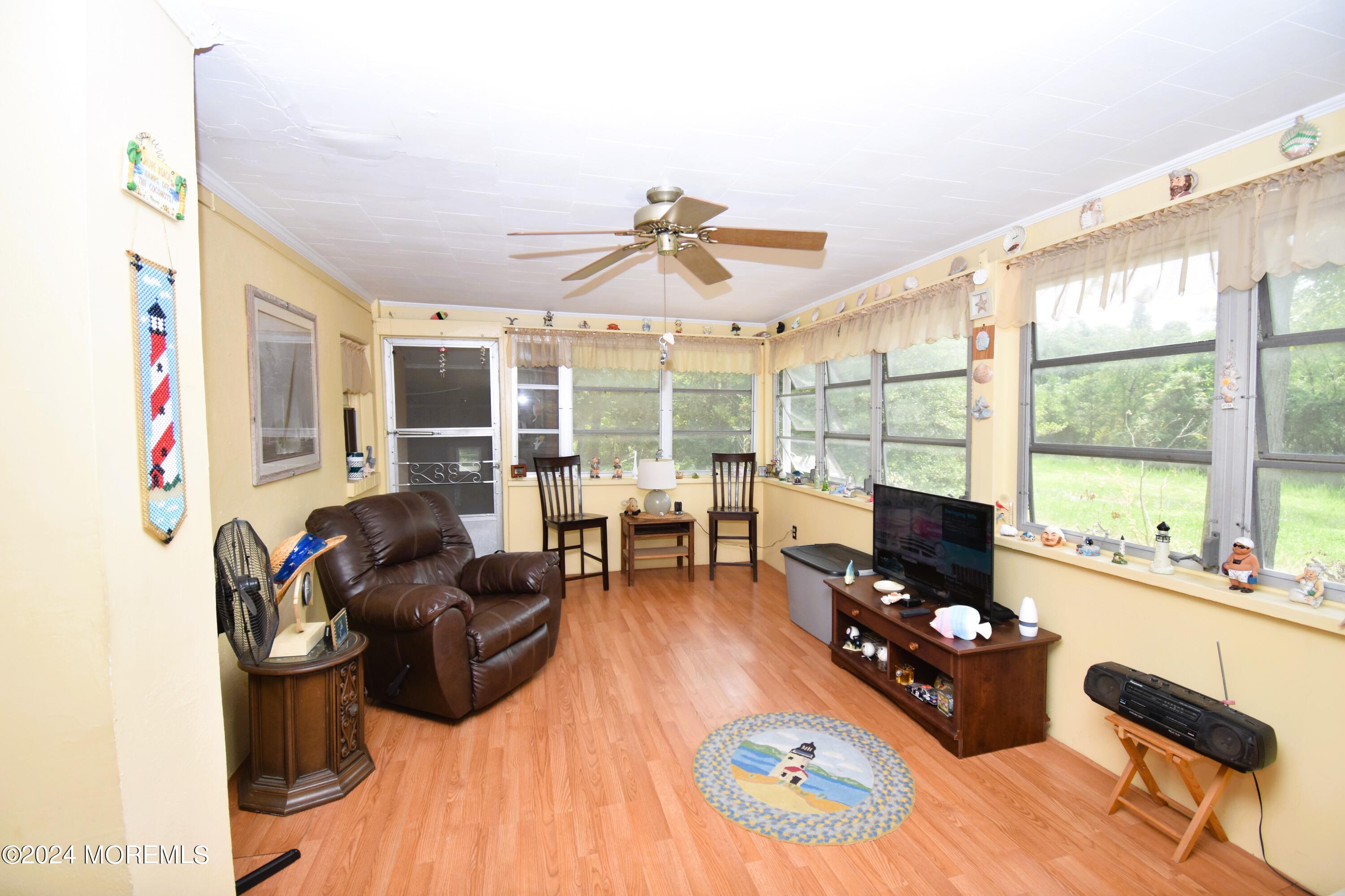 a living room with furniture and floor to ceiling windows