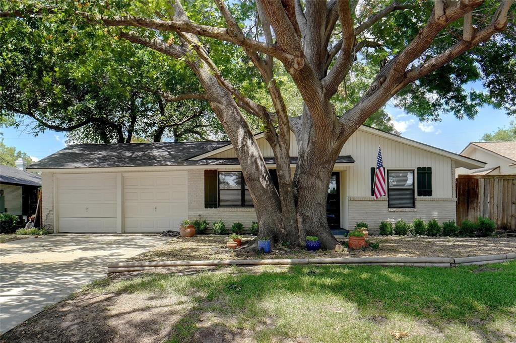 a front view of house with yard and trees