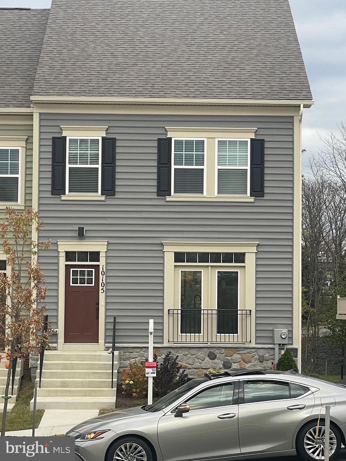 a front view of a house with a parking space