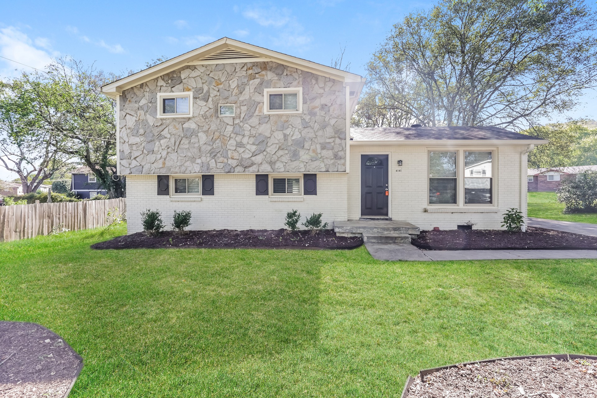 a view of a house with a yard and a garden