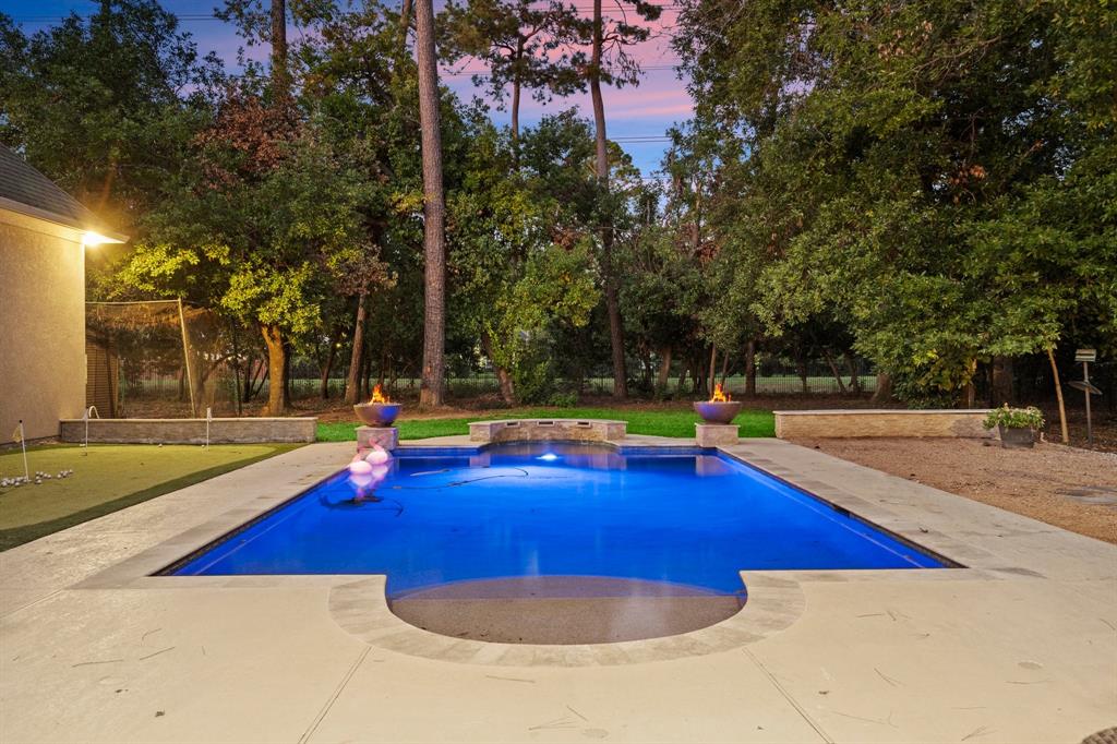 a view of pool with yard and seating area