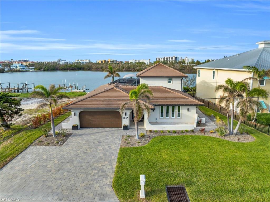 aerial view of a house with a garden and lake view