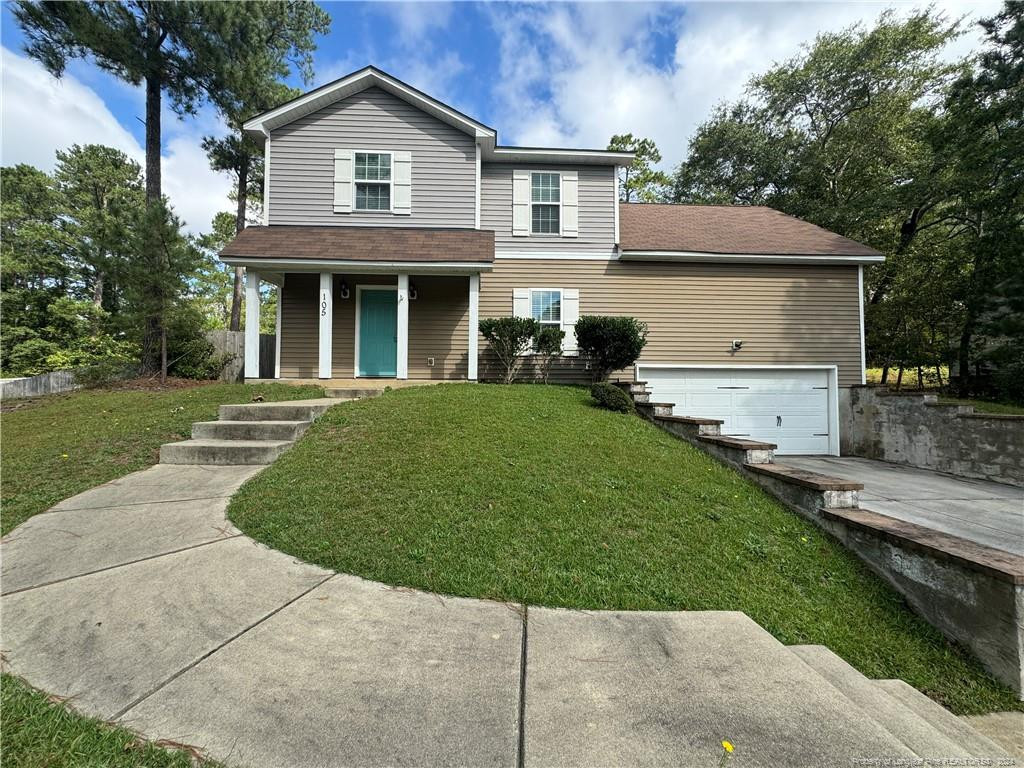 a front view of a house with a yard and garage