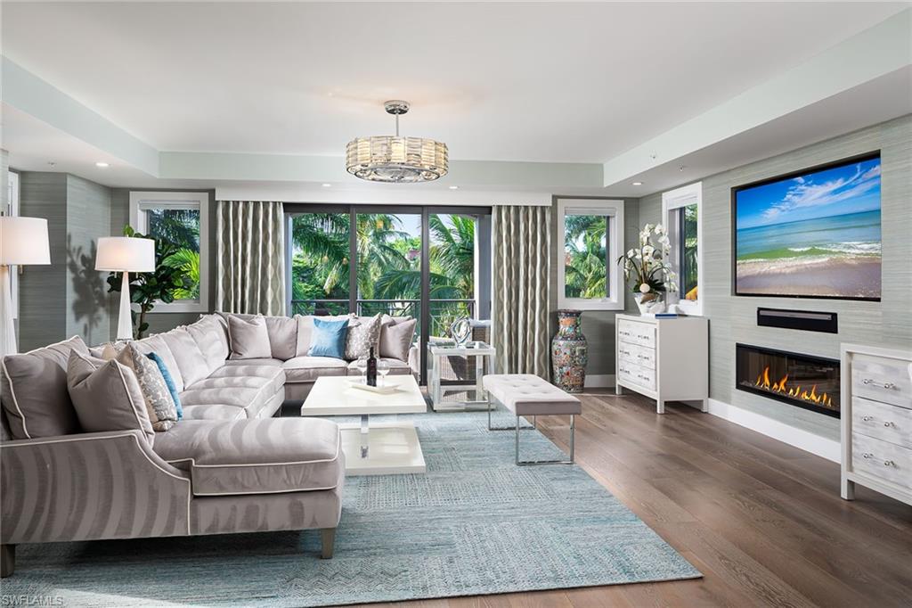 a living room with furniture a fireplace and a flat screen tv