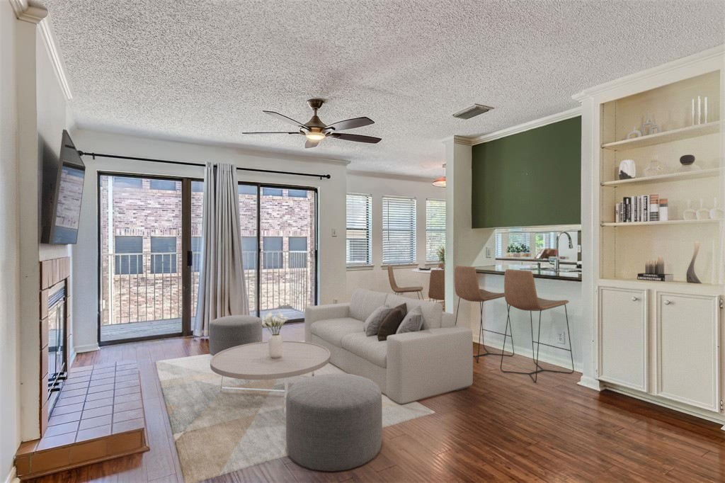 a living room with furniture a flat screen tv and a large window