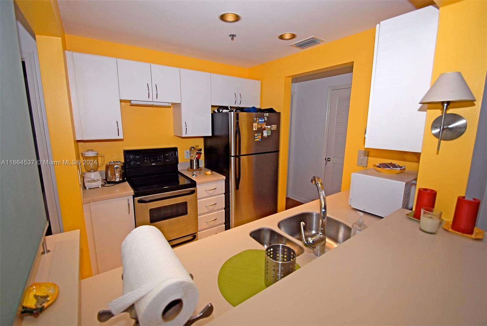 a kitchen with sink refrigerator and stove