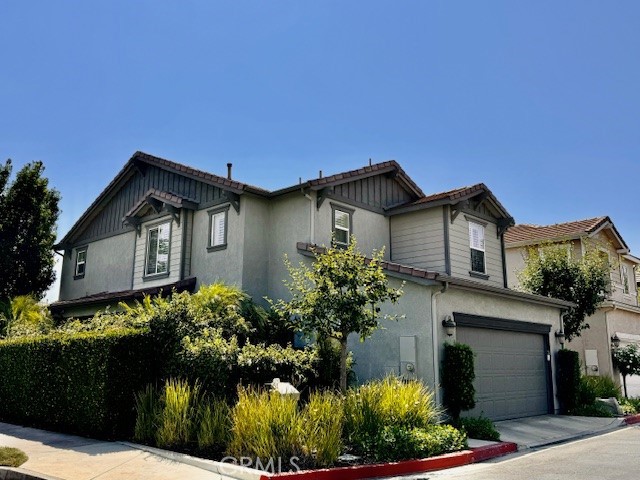 a front view of house with a garden