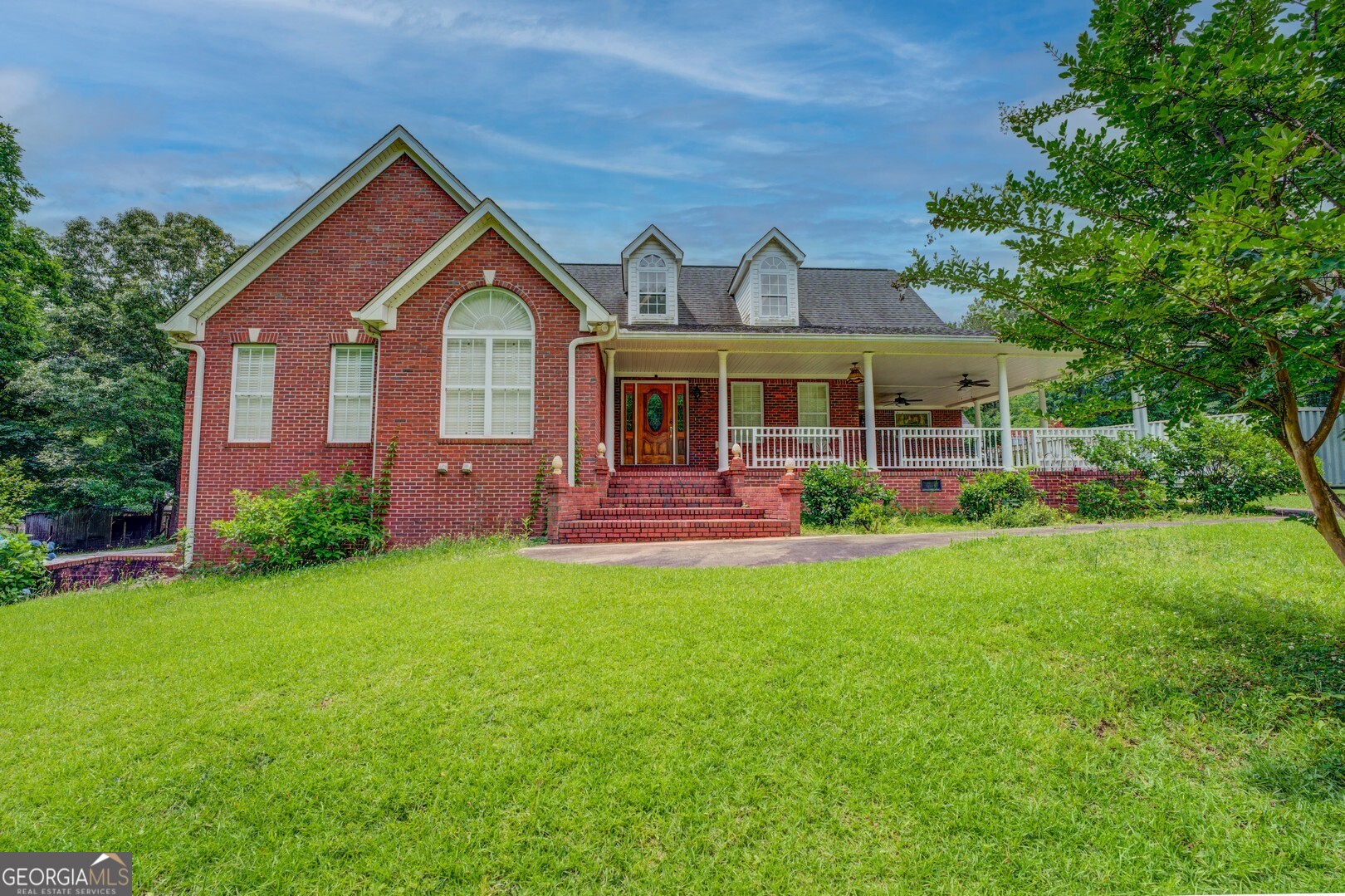 a front view of a house with garden