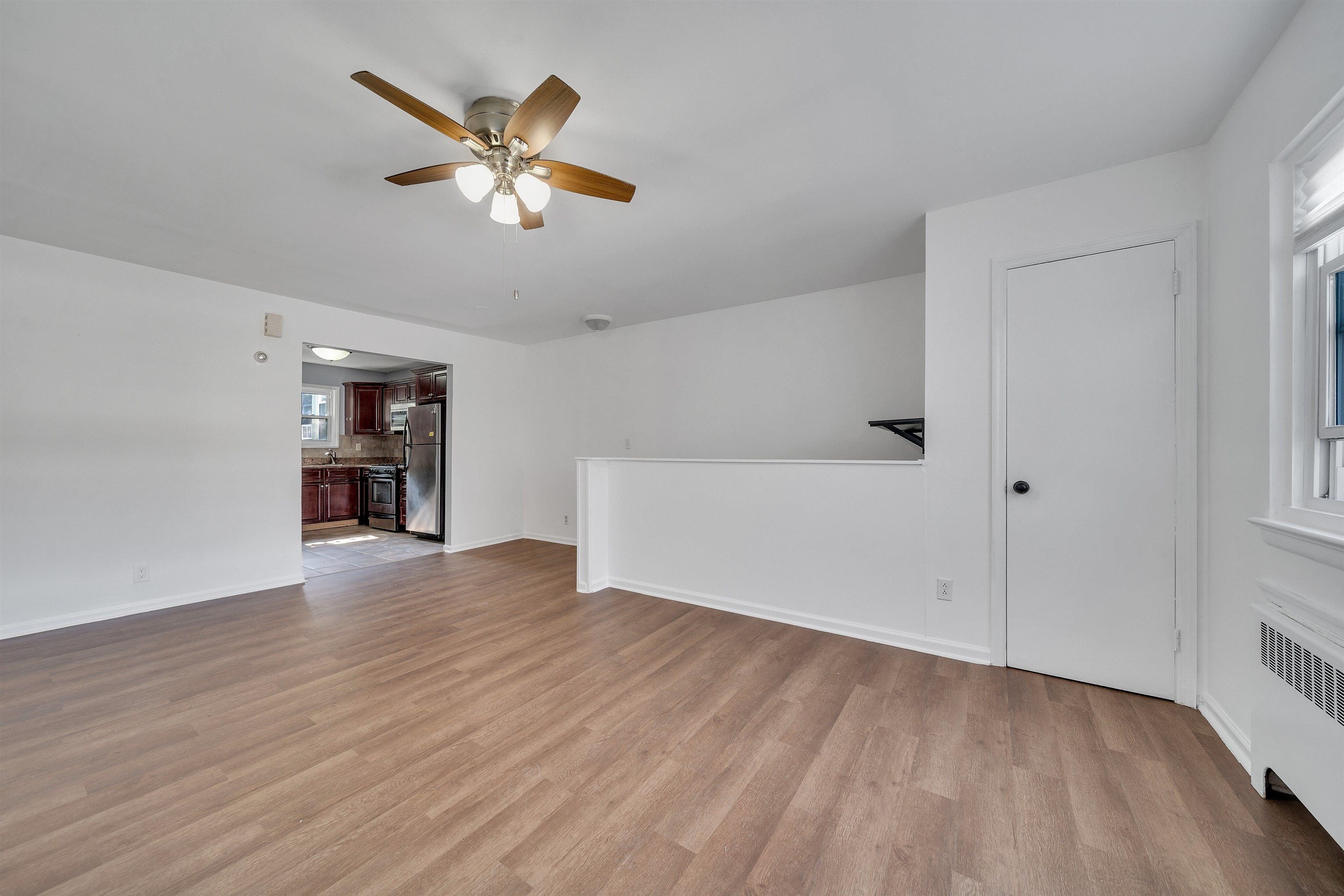 wooden floor in an empty room with a window