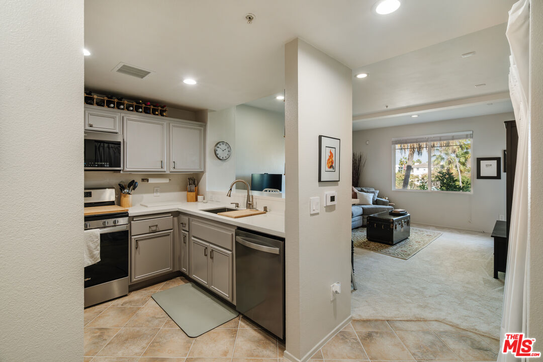 a kitchen with cabinets and chairs