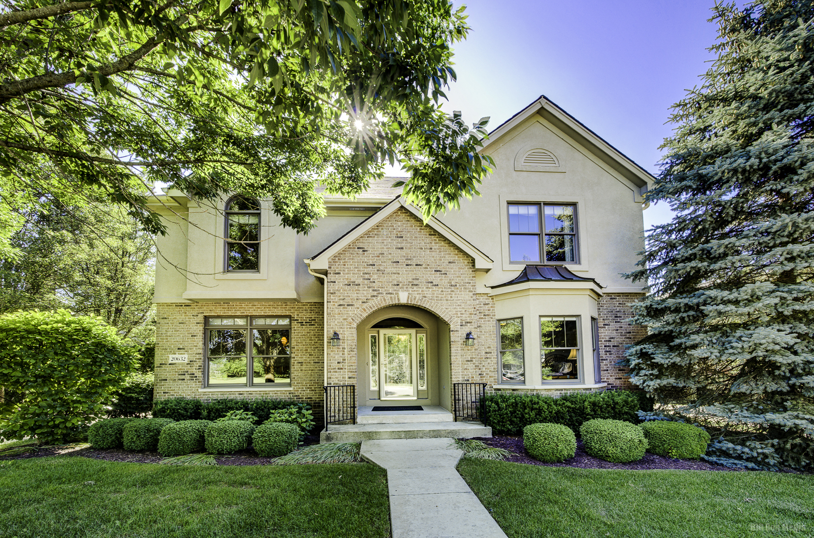 a front view of a house with garden