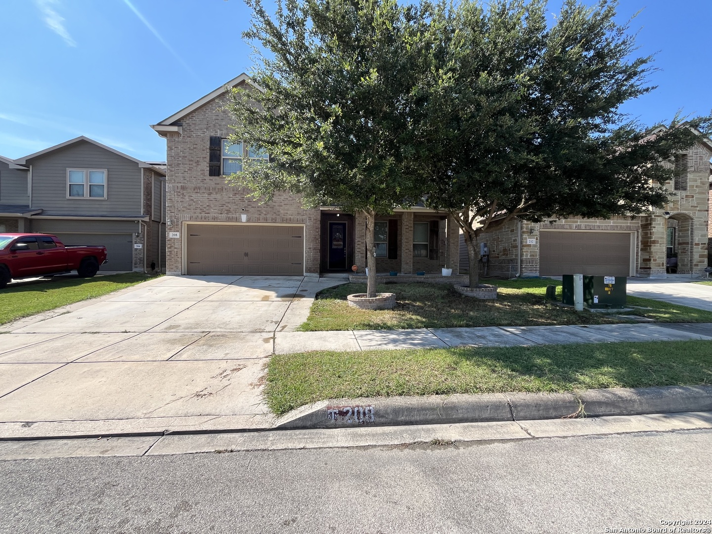 a front view of a house with a yard and a garage